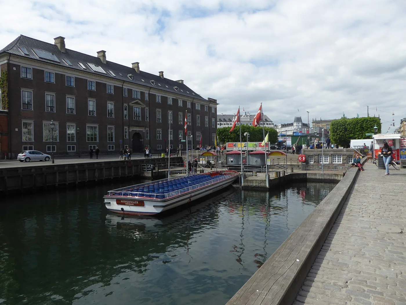 A canal tour boat docked at the Nyhavn departure quay in Copenhagen