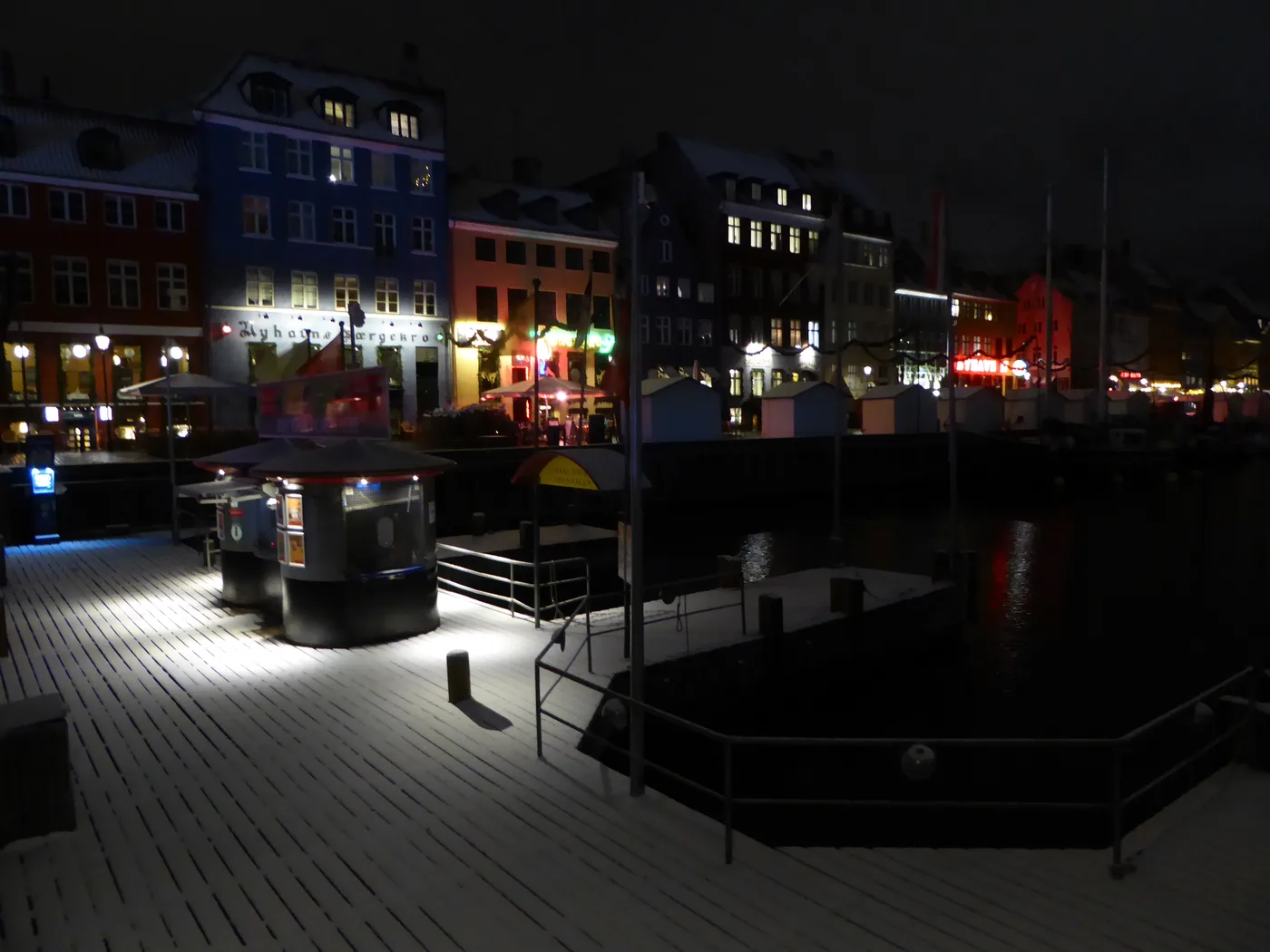 Nyhavn townhouses lit up on a snowy winter evening, Copenhagen